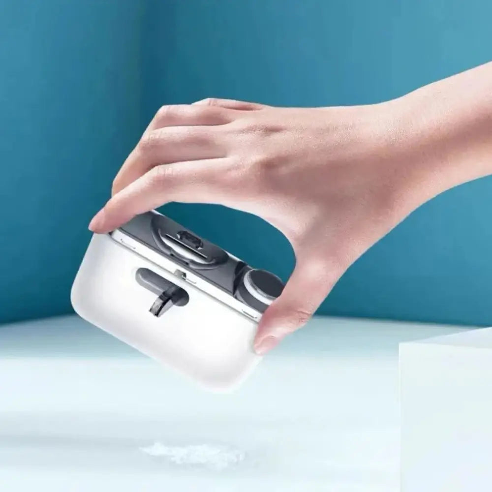 A hand holding the electric nail clipper and polisher